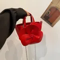 Elegant red handbag featuring a large 3D flower petal design and silver chain strap - Red