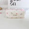 Macro detail view of a retro floral corduroy pencil case with MAY RABBIT brand label. - Pink Blue Rose