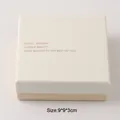 Detail of minimalist beige jewelry gift box with printed elegant quotes and size - Packaging Box (9x9x3cm)