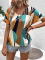 Close-up of women's V-neck loose shirt featuring a colorful geometric print pattern - S / Lake Blue