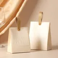 Elegant cream-colored wedding candy box with leather-style texture and gold handle - Champagne Box + Leather Handle