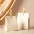 Elegant cream-colored wedding candy boxes with 'Sweet Time' embossed and faux leather handles - Champagne Box + Yellow Leather Handle