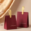 Elegant burgundy candy gift boxes with gold handles and sweet embossed text detail - Wine Red Box + Yellow Leather Handle