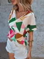 Close-up detail of women's V-neck shirt featuring a vibrant geometric triangle print - S / Floral Print 4