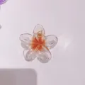 Elegant plumeria flower hair claw clip featuring an orange gradient for beach style - 8cm Clear with Orange Core