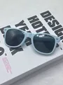 Detailed shot of baby blue candy-colored vintage sunglasses with silver rice nail accents - Light Blue