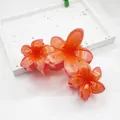 Vibrant orange floral hair claw clip with glossy frangipani design for elegant styling - 11cm Triple Plumeria Style / Orange Red
