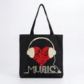 Close-up of artistic red heart and headphone music print on black canvas tote bag - Headphone Heart Notes Black Style (hm7326)