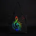 Macro view of a black canvas tote bag with a vibrant rainbow treble clef and musical note print - Rainbow Treble Clef Black Style (hm7330)