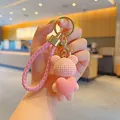 Handcrafted pink knitted bear keychain featuring a heart charm and stylish woven strap - Heart Hug Bear / Pink