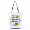 Close-up of a white tote bag with colorful flower patterns and positive English text - Floral Art Letter Slogan (hl5280)