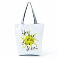 Detail shot of a stylish white tote bag featuring a yellow sun and Sun shine print. - Bright Yellow Sun Letter (hl5281)