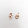 Close-up of two rose gold 18K gold plated lobster clasps for DIY jewelry making - Rose Gold