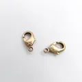 High-quality close-up of 18K gold plated copper lobster clasps for DIY jewelry making. - Raw Copper