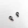 Macro view of high-quality gunmetal lobster clasps for DIY jewelry making and necklaces. - Gunmetal