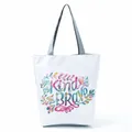 Detailed view of a white tote bag featuring colorful 'Be Kind Be Brave' floral typography. - Colorful Inspirational Letter Floral (hl5287)