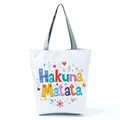 Detailed view of white canvas tote bag with vibrant Hakuna Matata floral letter print - Hakuna Matata Letters (hl5293)