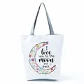 Detailed view of the floral crescent moon and quote print on a white canvas tote bag - Crescent Floral Quote (hl5294)