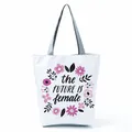Close-up detail of the floral print and slogan on this white canvas shoulder tote bag - Flowers Surround Slogan (hl5296)