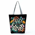 Detailed view of the vibrant floral and letter print on a stylish black canvas tote bag - Black Abstract Floral Slogan (hl5298)