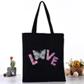 Casual black canvas tote bag featuring a pink glittery LOVE print and butterfly - Glitter LOVE Butterfly Style (L4228-5) / Black