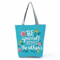 Front view of a stylish blue tote bag featuring colorful floral and motivational text print. - Sky Blue Floral Inspirational (hl5302)
