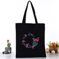 Black canvas tote bag featuring a vibrant colorful butterfly print in a circular design - Circular Arranged Colorful Butterflies Style (L4228-12) / Black