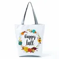 Close-up detail of a white canvas tote bag featuring a floral wreath and Happy Fall text - Colorful Floral Ring (hl5318)
