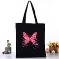 Black canvas tote bag featuring a pink petal butterfly print for students - Pink Petal Butterfly Style (L4228-15) / Black