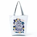 Close-up of white tote bag featuring a floral wreath and Proverbs 31:28 scripture quote - Floral Wreath Quote (hl5320)