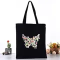 Black canvas tote bag featuring a colorful butterfly series collage print design - Multi-colored Butterfly Silhouette Style (L4228-17) / Black