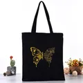 Black canvas tote bag featuring a golden butterfly graphic and motivational English quote - Golden Butterfly Letter Print Style (L4228-19) / Black