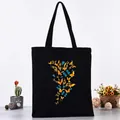 Black canvas tote bag featuring vibrant butterfly print series - Colorful Butterfly Stacking Style (L4228-22) / Black