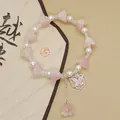 Forest style handmade beaded bracelet featuring pink lily flowers and a silver butterfly charm - Colorful Butterfly Lily of the Valley Pink