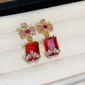 Close-up of elegant palace-style earrings with red square zircon and floral details - Gold-Red