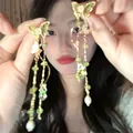 Detailed view of vintage butterfly earrings with green crystal tassels and pearls. - Butterfly Crystal Long Tassel Style (17#)