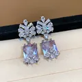 Detailed view of elegant square purple zircon earrings with sparkling floral clusters - Silver-Purple