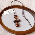 Close-up detail of retro wax cord necklace featuring irregular amber-textured oval resin pendants - Columnar Style (HN9996)