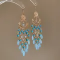 Bohemian tassel earrings with gold finish, turquoise beads, and light blue teardrops. - Turquoise Seed Bead Tassel Style (24#)