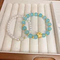 Elegante conjunto de pulseras de perlas y cuentas azules con flor dorada - Pulsera 38# (Juego de 2 Piezas) / Azul