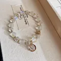 Elegante pulsera de cuentas blancas esmeriladas y cristal con detalles dorados y dije - 40# Pulsera / Cristal Blanco