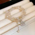 Elegante pulsera de cuentas en capas con dije de camelia y perla en color beige lácteo - Pulsera de Doble Capa 49# (Colgante de Camelia) / Ojo de Gato Amarillo Naranja Claro