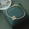 Elegant gold-plated flower bracelet with sparkling zircons on a green jewelry box - 80# Bracelet - Gold - Flower (real Gold Plated)