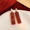 Festive red flocked earrings with carved Chinese luck characters on white plate background. - Great Luck and Prosperous Flocking Drop Earrings (84#) / Red-Gold