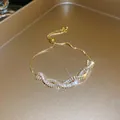 Elegante Nahaufnahme eines funkelnden Zirkonia-Armbands mit verstellbarer Goldkette - Stil 57 / Gold