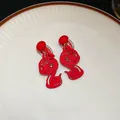 Festive red snake clip-on earrings with cute Chinese zodiac design and flocked finish. - Zodiac Snake Shape (100#) / Clip-On Earrings / Red