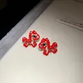 Close-up of red hollow horse stud earrings with sparkling black stone accents - Hollow Horse (20#)