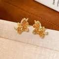 Macro view of gold-plated unicorn stud earrings with sparkling crystal pavé accents - Unicorn (16#)
