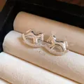 Elegant silver-colored hammered rocking horse stud earrings displayed in jewelry box - Textured Rocking Horse (12#)