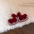 Elegant red velvet rocking horse earrings with pearl accents and gold bow detail - Hook Flocked Horse (31#)